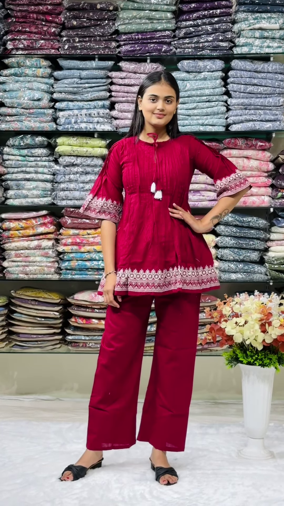 Women’s Red Embroidered Kurti Pant Set – White Threadwork Details with Boutique Shelf Backdrop